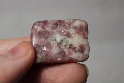 Polished purple-pink and white stone.